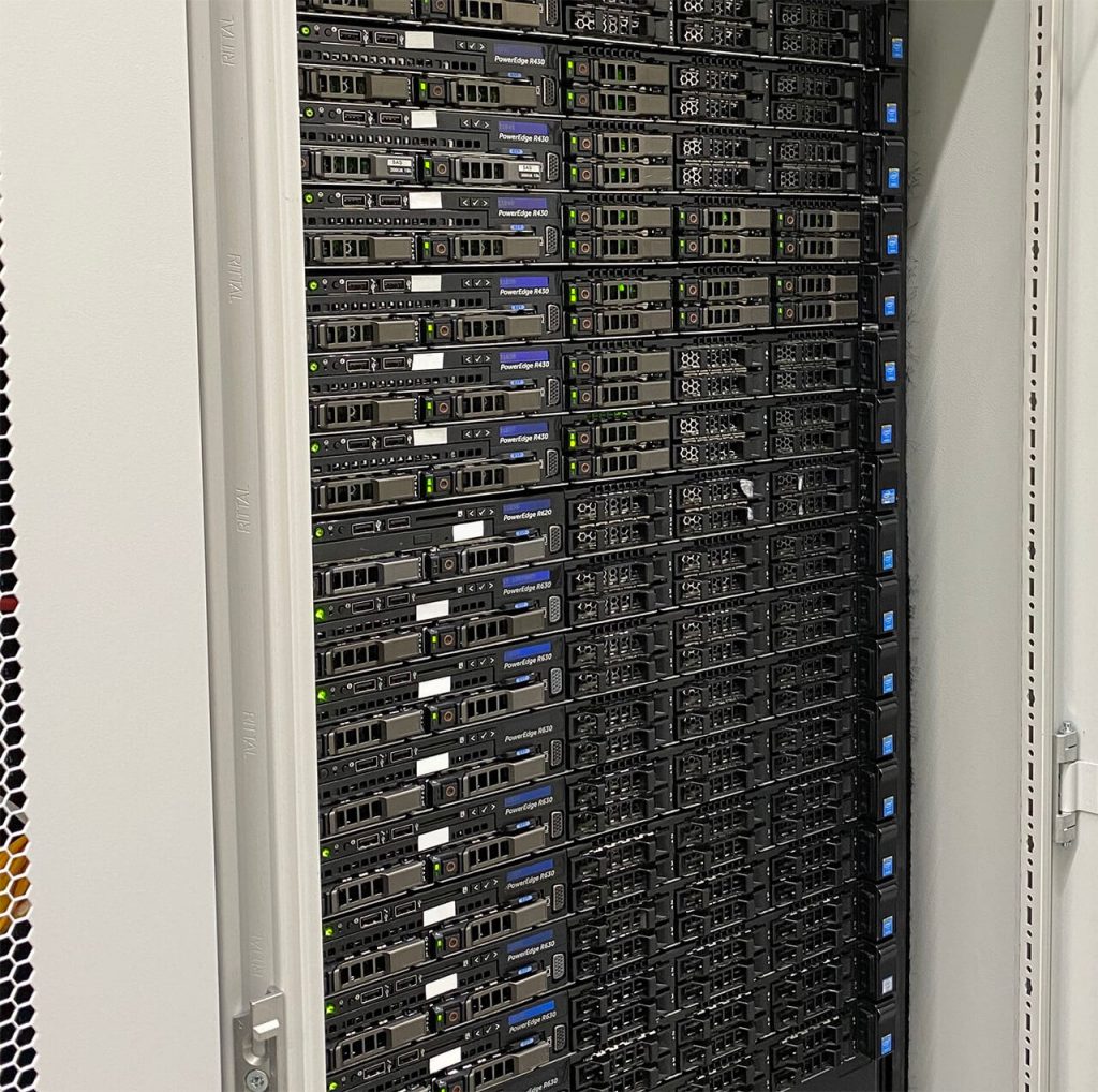 A server rack filled with multiple Dell PowerEdge R620 servers, each with visible status lights and ventilation panels.